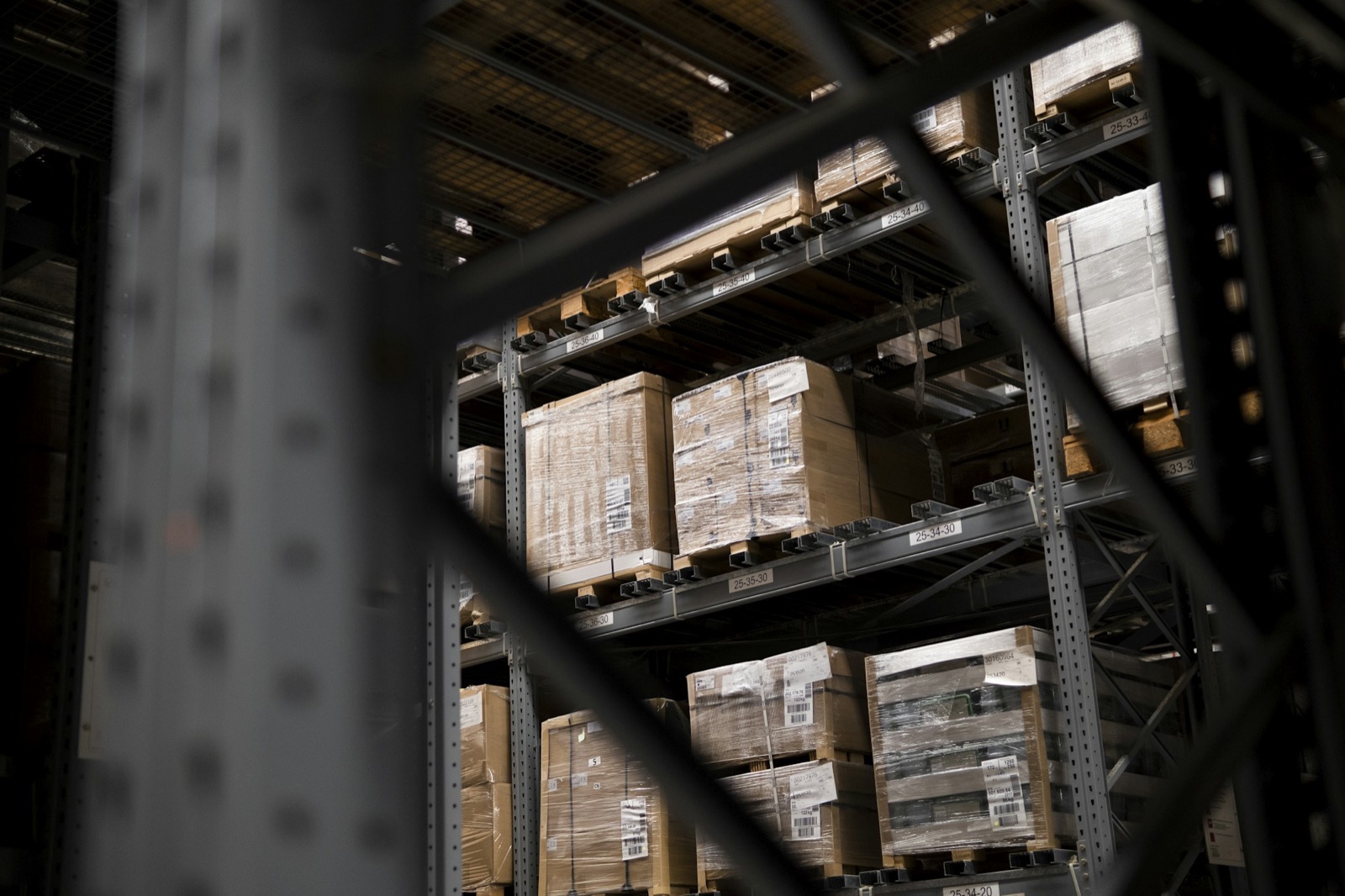Palletised and shrink-wrapped cartons stored on warehouse racking