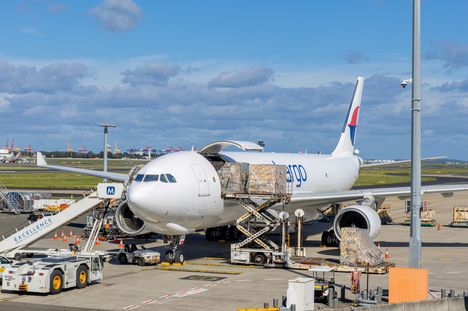 Cargo pallets being loaded through the side door of a freighter aircraft